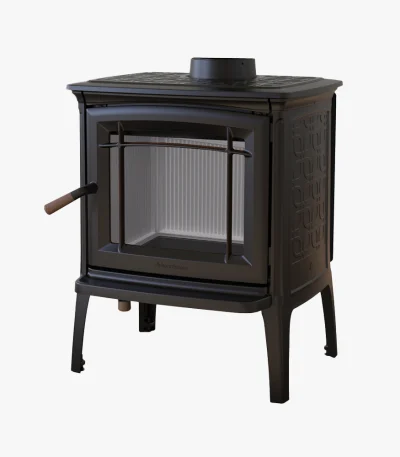 Hergom Craftsbury HF är en vedeldad kamin i svart gjutjärn med glasdörr, sidohandtag och dekorativa sidomönster, med fyra robusta ben och visas mot en vit bakgrund.